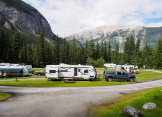Fox & Friends RV Giveaway at Liberty State Park Sparks Mixed Feelings A beautiful campsite featuring RVs amidst lush forests and towering mountains for a peaceful getaway.