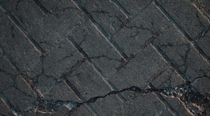 Hoboken finally funds study for crumbling Castle Point Terrace Close-up view of cracked urban pavement showing detailed texture and surface damage.