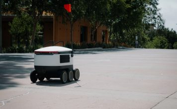 Hoboken rolls out robot sidewalk survey, and wants your input A sleek autonomous food delivery robot navigates a sunny urban landscape, showcasing modern innovation.
