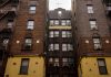 How to Find an Apartment in West New York: A 2026 Guide for Renters Low-angle view of urban brick apartment buildings with fire escapes, embodying classic city architecture.