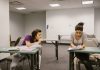 How to Get Your GED in North Bergen, NJ: A Complete 2026 Guide Two college students in a classroom setting, one appears to be copying from the other's paper.