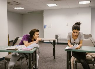 How to Get Your GED in North Bergen, NJ: A Complete 2026 Guide Two college students in a classroom setting, one appears to be copying from the other's paper.
