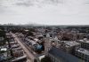 Aerial view showcasing Philadelphia's skyline and urban landscape with a historic church in the foreground.