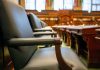 Jersey City Council ceremonies drag meetings, resident says in letter Elegant courtroom seating with leather chairs and wooden desks, exuding a sense of authority.