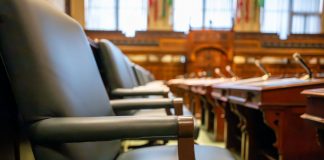 Jersey City Council ceremonies drag meetings, resident says in letter Elegant courtroom seating with leather chairs and wooden desks, exuding a sense of authority.