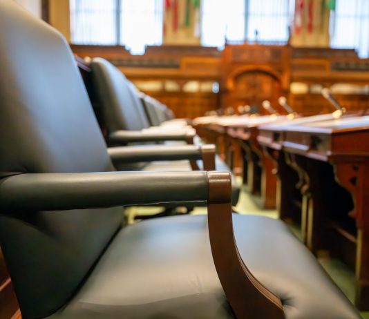 Jersey City Council ceremonies drag meetings, resident says in letter Elegant courtroom seating with leather chairs and wooden desks, exuding a sense of authority.