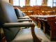 Elegant courtroom seating with leather chairs and wooden desks, exuding a sense of authority.