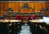Spacious and elegant wooden courtroom with empty seats, located in Bern, Switzerland.