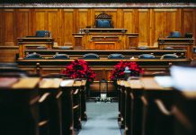 Spacious and elegant wooden courtroom with empty seats, located in Bern, Switzerland.