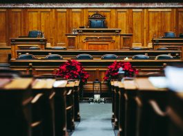 Spacious and elegant wooden courtroom with empty seats, located in Bern, Switzerland.