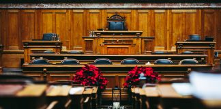 Spacious and elegant wooden courtroom with empty seats, located in Bern, Switzerland.