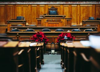 Spacious and elegant wooden courtroom with empty seats, located in Bern, Switzerland.