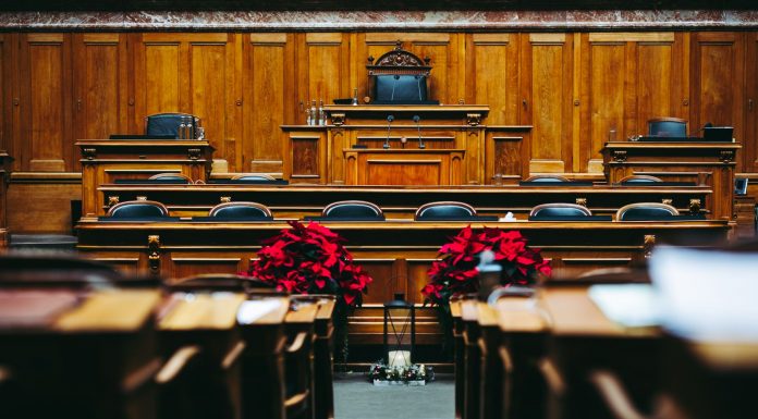 Spacious and elegant wooden courtroom with empty seats, located in Bern, Switzerland.