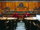 Spacious and elegant wooden courtroom with empty seats, located in Bern, Switzerland.