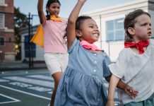 Jersey City Families Find Summer Fun Close to Home Three kids enjoying superhero play on a sunny outdoor court.