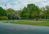 Jersey City Mom Scores World Cup Tickets and $20K After Random Act of Kindness A father and child enjoy playing basketball on an outdoor court in a green, tranquil park setting.