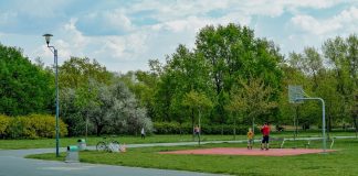 Jersey City Mom Scores World Cup Tickets and $20K After Random Act of Kindness A father and child enjoy playing basketball on an outdoor court in a green, tranquil park setting.
