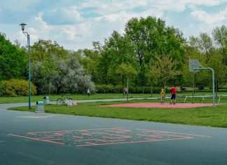 Jersey City Mom Scores World Cup Tickets and $20K After Random Act of Kindness A father and child enjoy playing basketball on an outdoor court in a green, tranquil park setting.