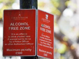 Close-up of red Cheltenham alcohol-free zone sign with maximum penalty warning.