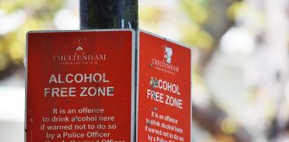 Close-up of red Cheltenham alcohol-free zone sign with maximum penalty warning.