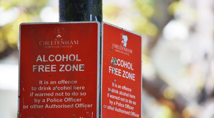 Jersey City Moves to Block AI Data Centers from Zoning Close-up of red Cheltenham alcohol-free zone sign with maximum penalty warning.