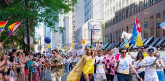 Colorful Pride Parade with diverse participants celebrating in Toronto's vibrant streets.