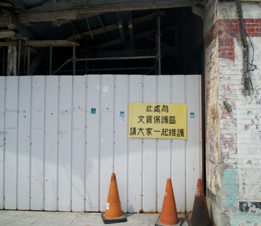 Jersey City’s Big Promises That Went Nowhere Abandoned building site with a warning sign and orange cones.