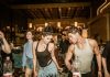 Group of young adults enjoying a lively night out at a trendy Indian bar with friends.