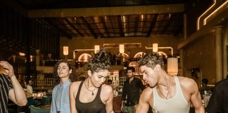 Group of young adults enjoying a lively night out at a trendy Indian bar with friends.