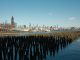 Scenic view of New York City skyline from Hoboken waterfront with wooden piers in the foreground.