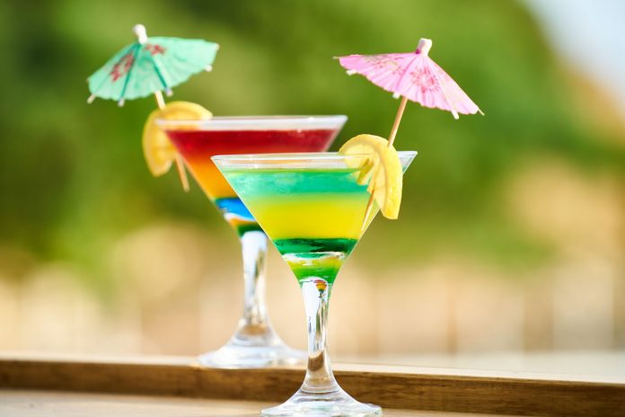 Vibrant cocktails with lemon slices and umbrellas, perfect for summer celebrations.