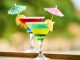 Vibrant cocktails with lemon slices and umbrellas, perfect for summer celebrations.
