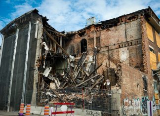 Scene of a partially demolished brick building in Montreal, showcasing urban decay and redevelopment.