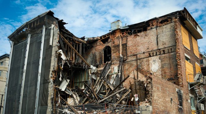 Scene of a partially demolished brick building in Montreal, showcasing urban decay and redevelopment.