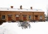 Bicycles parked in front of a snow-covered brick building in Jönköping, Sweden.