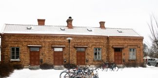 Bicycles parked in front of a snow-covered brick building in Jönköping, Sweden.