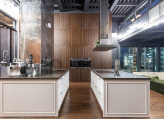 Interior of contemporary spacious kitchen with stylish furniture in apartment with loft style