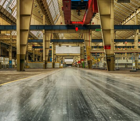 Mars Wrigley Leaving Newark, 307 Jobs Lost by October Wide view of an empty industrial warehouse with visible cranes and metal structures.