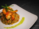 Savory prawn fried rice garnished with chives on a stylish white plate, capturing gourmet cuisine.