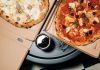 Top view of delicious pizzas in boxes with a refreshing drink, perfect for a cozy meal.