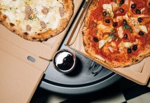 Top view of delicious pizzas in boxes with a refreshing drink, perfect for a cozy meal.