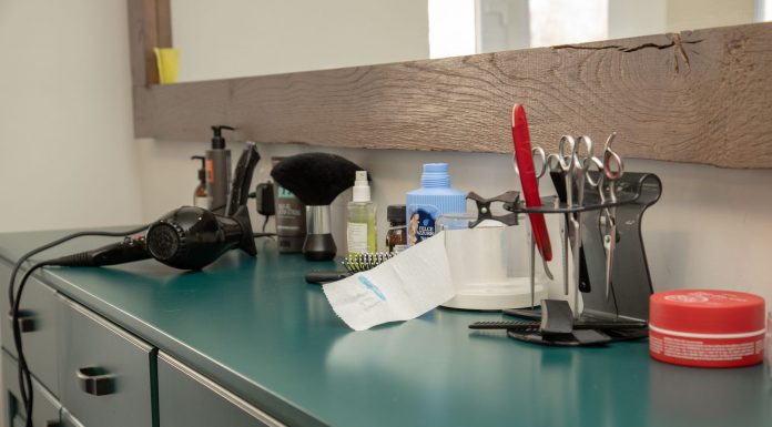 A well-organized salon workspace featuring essential hair styling tools on a cabinet.