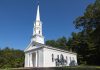 Charming white church with steeple surrounded by trees in Sudbury, Massachusetts.