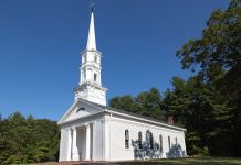 Charming white church with steeple surrounded by trees in Sudbury, Massachusetts.