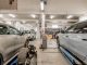 Interior of an automotive repair shop with cars undergoing maintenance and servicing.
