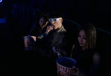 Movies in the Park returns to Hudson County with free summer screenings A group of young adults enjoying a movie at the cinema, complete with popcorn and 3D glasses.