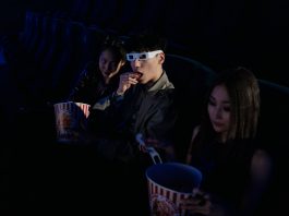Movies in the Park returns to Hudson County with free summer screenings A group of young adults enjoying a movie at the cinema, complete with popcorn and 3D glasses.