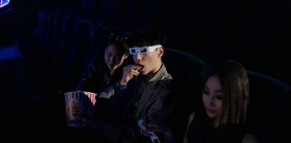 Movies in the Park returns to Hudson County with free summer screenings A group of young adults enjoying a movie at the cinema, complete with popcorn and 3D glasses.