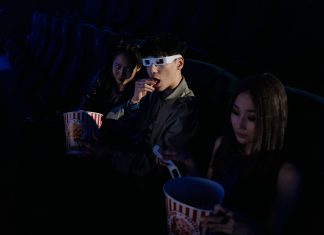 Movies in the Park returns to Hudson County with free summer screenings A group of young adults enjoying a movie at the cinema, complete with popcorn and 3D glasses.