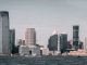 A breathtaking view of Jersey City's skyline from across the Hudson River with modern skyscrapers and waterfront buildings.